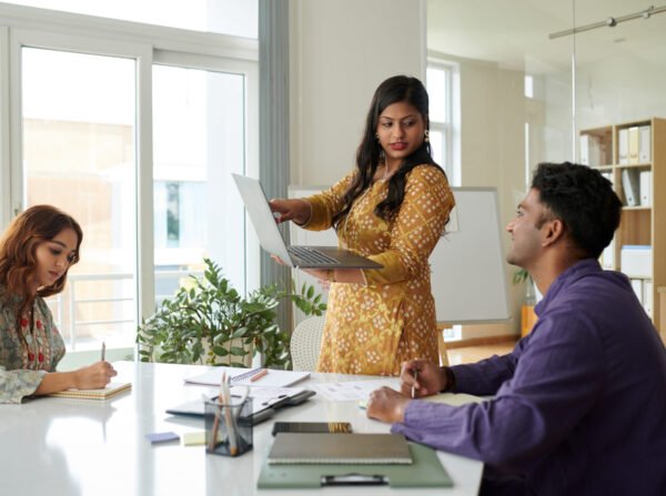 Businesswoman Showing Product Presentation Indian businesswoman showing product presentation she created to colleagues in meeting